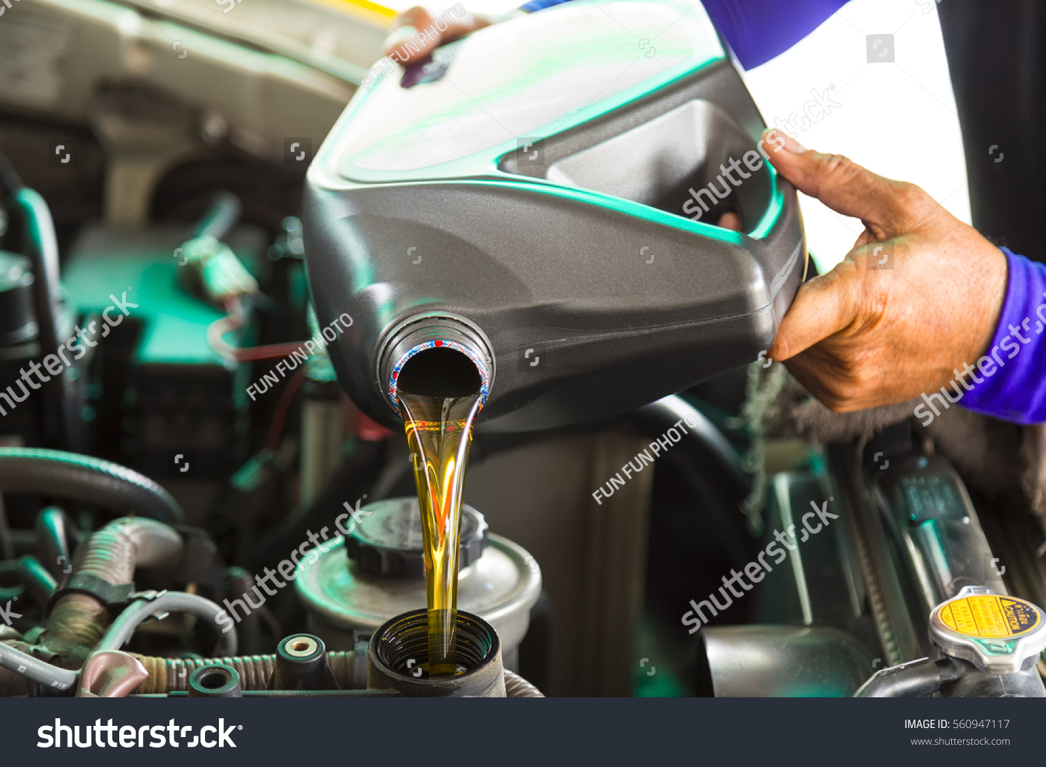 Stock Photo Car Mechanic Replacing And Pouring Fresh Oil Into Engine At